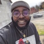 A person wearing glasses and a hat
Description automatically generated with medium confidence